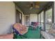 Screened in porch with comfortable seating and a ceiling fan to keep you cool at 7150 Eagle Cove Dr, Indianapolis, IN 46254