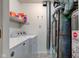 Functional utility room featuring a modern washer, dryer, furnace, and water heater at 7150 Eagle Cove Dr, Indianapolis, IN 46254