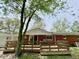 Backyard view with wooden deck and brick home exterior at 725 N State Road 75, Lebanon, IN 46052