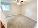Comfortable carpeted bedroom with neutral walls, ample natural light, and a ceiling fan at 725 N State Road 75, Lebanon, IN 46052