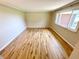 Spacious bedroom with hardwood flooring and a large window offering ample natural light at 725 N State Road 75, Lebanon, IN 46052