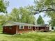 Charming red brick ranch home with well-maintained lawn and mature trees at 725 N State Road 75, Lebanon, IN 46052