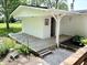 Inviting entryway of cottage-style outbuilding with landscaped surroundings at 725 N State Road 75, Lebanon, IN 46052