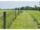 Lush green field with a fence, offering picturesque countryside living and land use at 725 N State Road 75, Lebanon, IN 46052