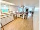 Bright eat-in kitchen featuring wooden floors, stainless steel appliances, and white cabinetry at 725 N State Road 75, Lebanon, IN 46052