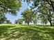 Picturesque view of a green field dotted with trees, creating a serene country landscape at 725 N State Road 75, Lebanon, IN 46052