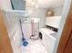 Functional laundry room with modern washer and dryer, shelving, and neutral decor at 725 N State Road 75, Lebanon, IN 46052