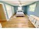 Bright main bedroom with hardwood floors, ceiling fan, and double closets at 725 N State Road 75, Lebanon, IN 46052