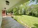 Inviting covered porch with a lovely view of the expansive, well-manicured front yard at 725 N State Road 75, Lebanon, IN 46052