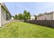 View of the backyard with well maintained lawn and wooden fence at 7639 Foxglove Ln, Noblesville, IN 46062