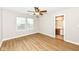 Bright bedroom with wood-look flooring, ceiling fan, and an ensuite bathroom at 7639 Foxglove Ln, Noblesville, IN 46062