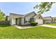 Inviting front of a cozy home features a manicured lawn and a classic design, with a two car garage at 7639 Foxglove Ln, Noblesville, IN 46062