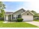 Charming single-story home with a well-manicured lawn and two car garage, perfect for suburban living at 7639 Foxglove Ln, Noblesville, IN 46062