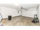 Spacious two car garage with concrete flooring at 7639 Foxglove Ln, Noblesville, IN 46062