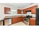 Traditional kitchen with stainless steel dishwasher and oven, wood cabinets and neutral countertops at 7639 Foxglove Ln, Noblesville, IN 46062