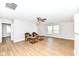 Spacious living area featuring wood-look floors, a ceiling fan, and plenty of room for personalized decor at 7639 Foxglove Ln, Noblesville, IN 46062