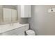 Bathroom featuring a shower with curtain, toilet and a vanity with mirror and cabinet at 7928 Vontress St, Coatesville, IN 46121