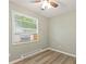 Bedroom with wood-look flooring, window and AC unit at 7928 Vontress St, Coatesville, IN 46121