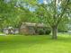 Charming brick home with a well-manicured front yard and mature trees for ample shade and curb appeal at 7928 Vontress St, Coatesville, IN 46121
