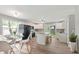 Modern kitchen featuring white cabinets, stainless steel appliances, an island, and adjacent dining area, perfect for entertaining at 7928 Vontress St, Coatesville, IN 46121