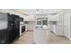 Modern kitchen with white cabinets, stainless steel appliances, an island, and adjacent dining area, perfect for entertaining at 7928 Vontress St, Coatesville, IN 46121