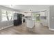 Modern kitchen with white cabinets, stainless steel appliances, an island, and adjacent dining area, perfect for entertaining at 7928 Vontress St, Coatesville, IN 46121