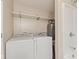 Laundry room with washer, dryer, water heater, shelving and a stand-up shower at 7928 Vontress St, Coatesville, IN 46121