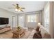 Bright living room with hardwood floors, large windows, and neutral paint tones, offering a cozy and inviting atmosphere at 7928 Vontress St, Coatesville, IN 46121