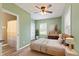 Calming main bedroom featuring a ceiling fan, natural light, and wood flooring offering a tranquil retreat at 7928 Vontress St, Coatesville, IN 46121