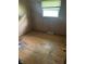 A cozy bedroom with wood-paneled walls, wood floors, and a window creating a warm and inviting atmosphere at 8312 Lamira Ln, Indianapolis, IN 46234