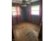 Bedroom featuring wood floors, gray walls, and windows offering bright natural light and views of the surrounding area at 8312 Lamira Ln, Indianapolis, IN 46234