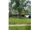 Charming brick home featuring an attached garage and a well-maintained front yard with mature trees at 8312 Lamira Ln, Indianapolis, IN 46234