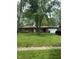 Charming brick home featuring an attached garage and a well-maintained front yard with mature trees at 8312 Lamira Ln, Indianapolis, IN 46234