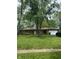 Charming brick home featuring an attached garage and a well-maintained front yard with mature trees at 8312 Lamira Ln, Indianapolis, IN 46234