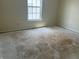 Bedroom featuring a window for natural light and damaged floor at 847 Sylvan St, Whiteland, IN 46184