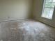 Bedroom featuring a window for natural light and damaged flooring at 847 Sylvan St, Whiteland, IN 46184