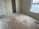 Bedroom with window view and closet showing damaged floor at 847 Sylvan St, Whiteland, IN 46184