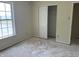 Bedroom with window view and closet showing damaged floor at 847 Sylvan St, Whiteland, IN 46184