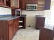Kitchen featuring wood cabinets, stainless steel microwave, and ample counter space at 847 Sylvan St, Whiteland, IN 46184