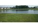 A calm pond is bordered by a lush green grassy bank at 847 Sylvan St, Whiteland, IN 46184