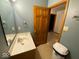Bathroom featuring a sink with a wood framed mirror and a standard toilet at 902 St Andrews Dr, Avon, IN 46123