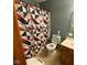 Bathroom featuring a toilet with a dark blue accent wall and a geometric patterned shower curtain at 902 St Andrews Dr, Avon, IN 46123