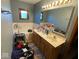Bathroom featuring a tub, double sink vanity, and a classic wood frame window at 902 St Andrews Dr, Avon, IN 46123