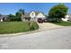 Charming two-story home with a well-manicured lawn, mature tree and convenient driveway parking at 902 St Andrews Dr, Avon, IN 46123