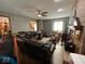 Spacious living room with hardwood floors, brick fireplace and a ceiling fan at 902 St Andrews Dr, Avon, IN 46123