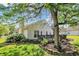 Charming backyard with a wooden deck, lush greenery, and mature trees creating a serene outdoor space at 9055 Glass Chimney Ln, Fishers, IN 46037