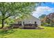 Picturesque backyard featuring a wooden deck, manicured lawn, and mature trees, great for outdoor gatherings at 9055 Glass Chimney Ln, Fishers, IN 46037