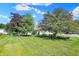 Spacious backyard with lush green grass and mature trees, perfect for outdoor activities and relaxation at 9055 Glass Chimney Ln, Fishers, IN 46037