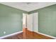 Stylish bedroom with hardwood floors, bi-fold doors to a closet, and a window at 9055 Glass Chimney Ln, Fishers, IN 46037