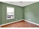 Charming bedroom featuring hardwood floors, a ceiling fan, and a window with views of the outdoors at 9055 Glass Chimney Ln, Fishers, IN 46037